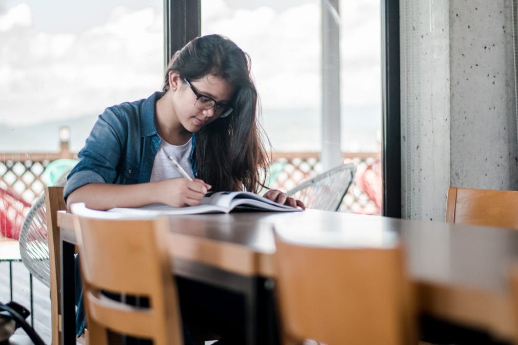 college student studying alone at table