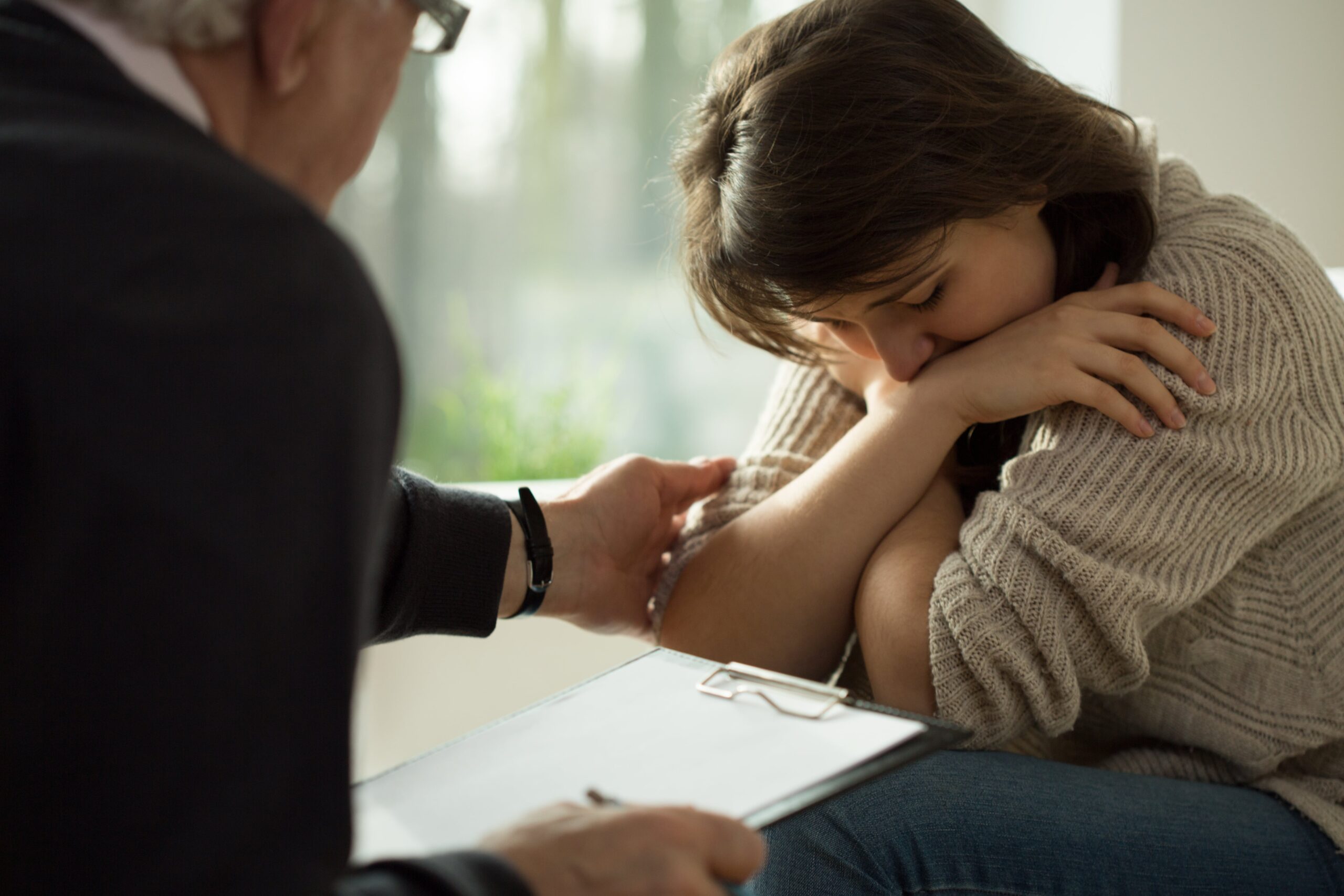 Doctor helping woman with depression and anxiety.