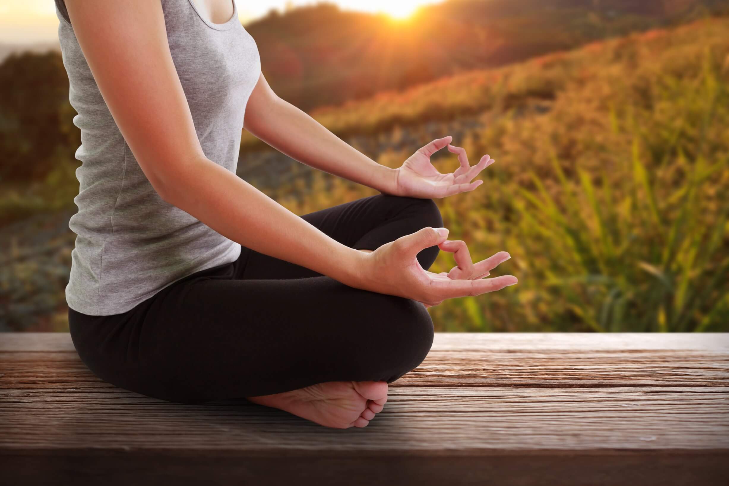 Woman practices mental wellness by meditating.