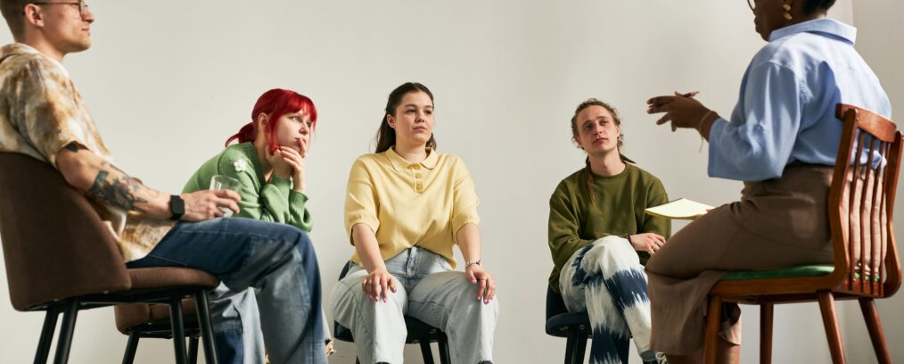 Group of young adults in group therapy for substance abuse.