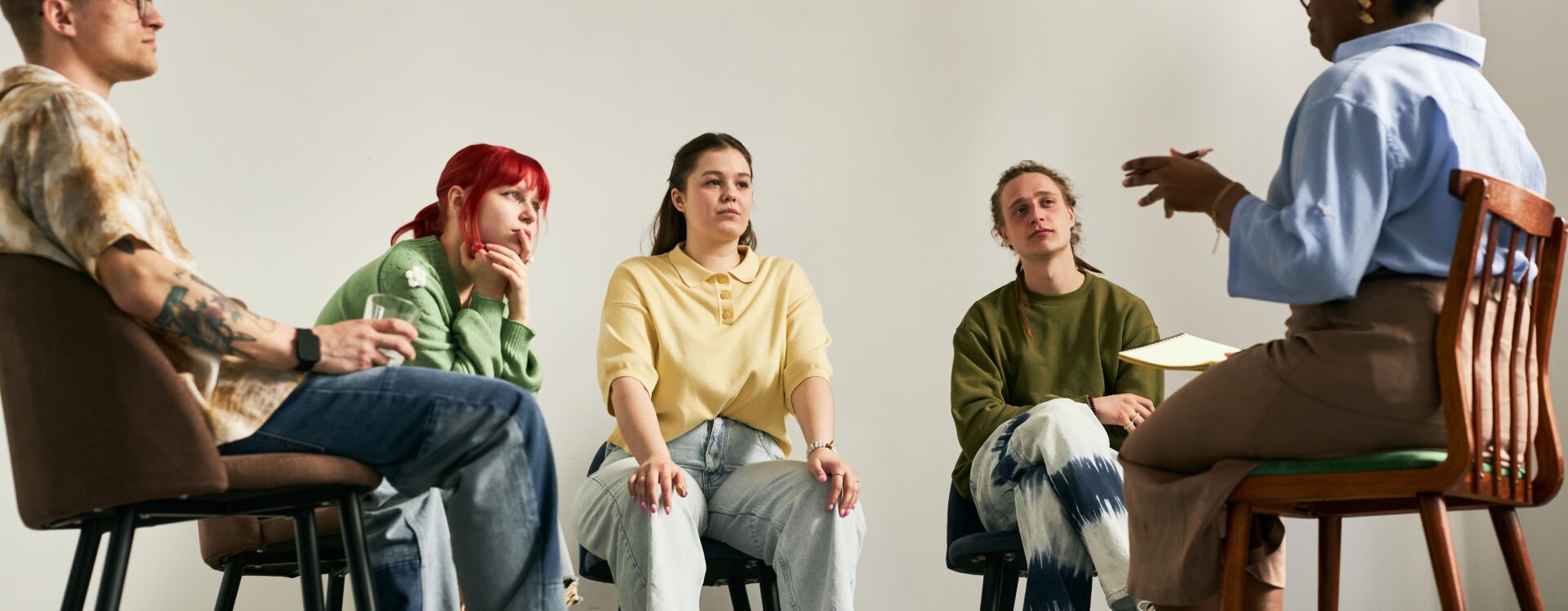 Group of young adults in group therapy for substance abuse.