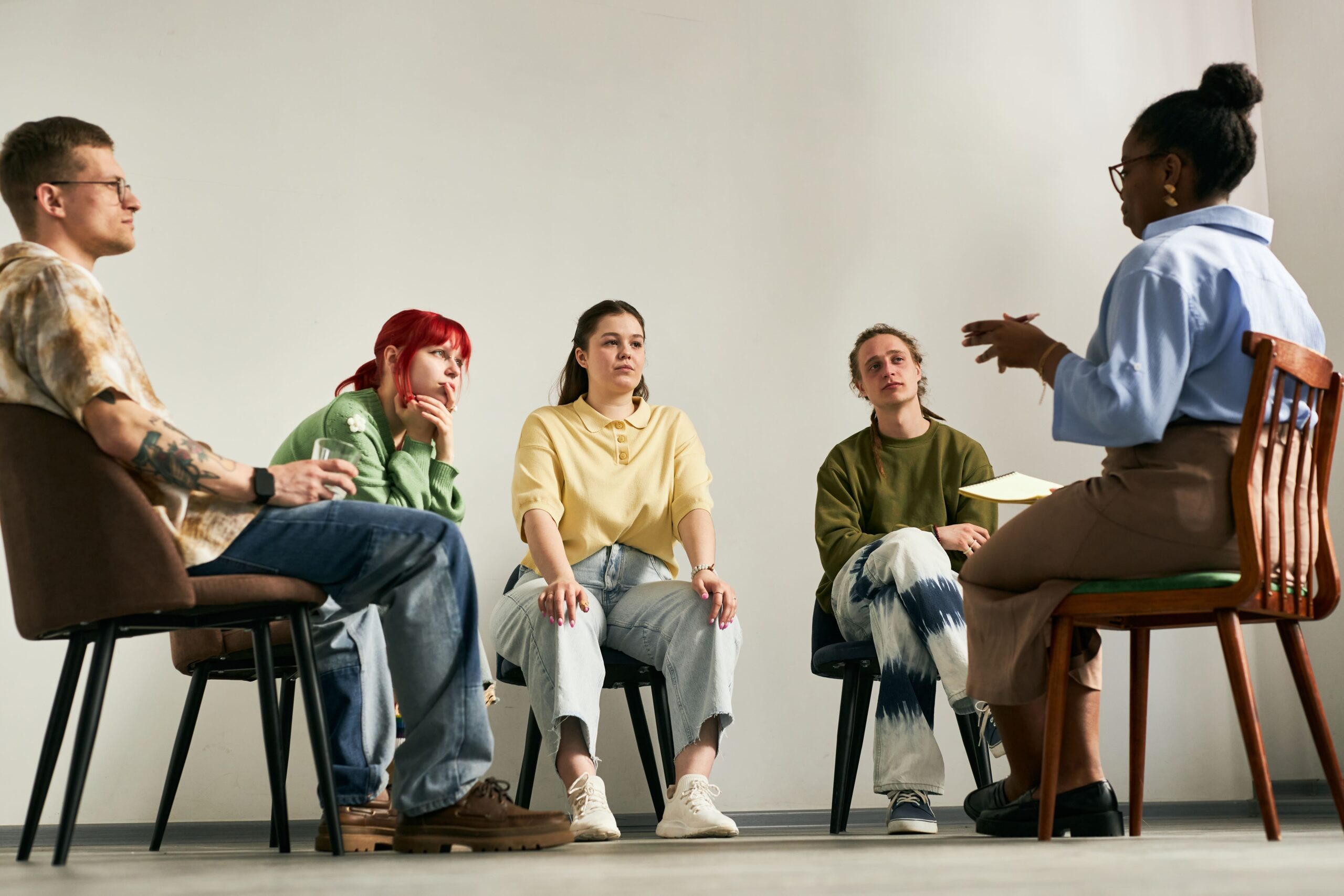 Group of young adults in group therapy for substance abuse.