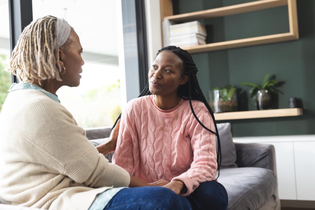 Young adult woman speaking to family member.