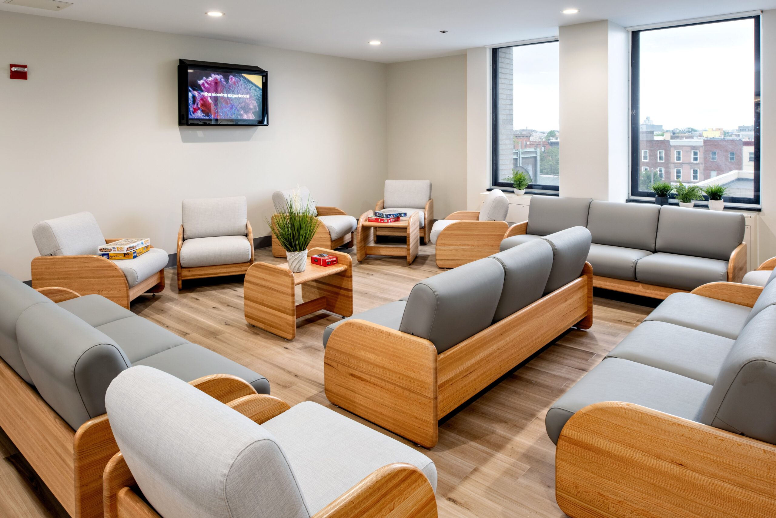 Picture showing Malvern Behavioral Clinic's waiting room with couches, tv and open windows.