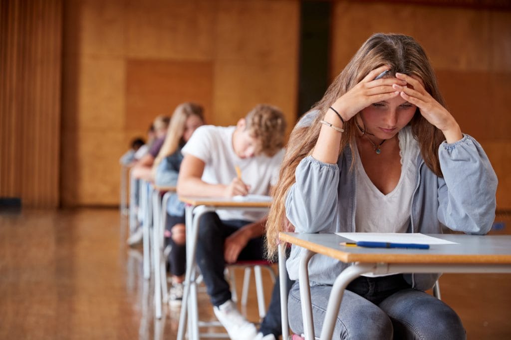 Anxious college student sitting in class.