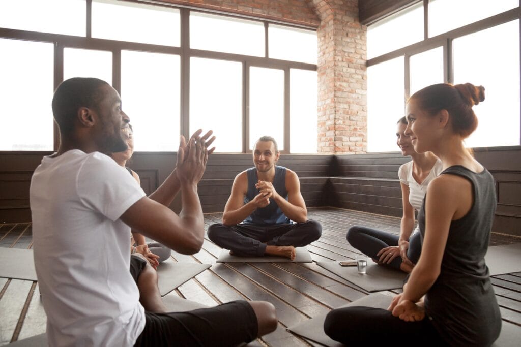 Group of young adults participating in yoga.