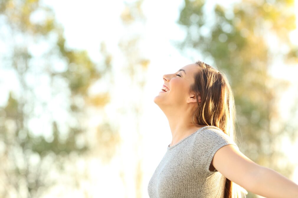 Young adult woman spending time outdoors, smiling.