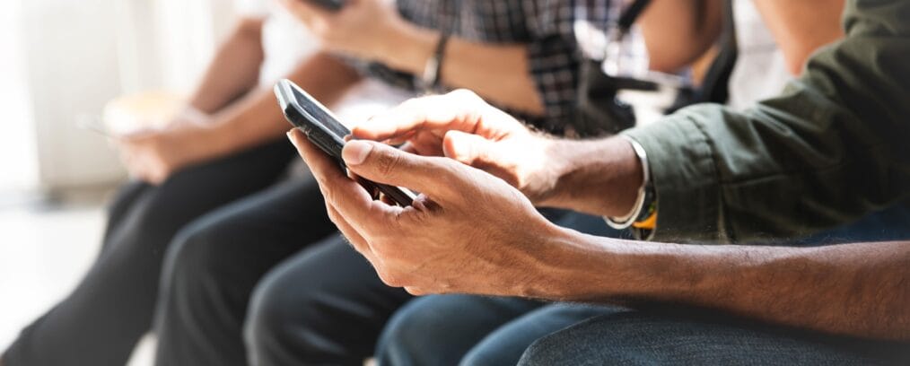 Young adults using social media on their phones.