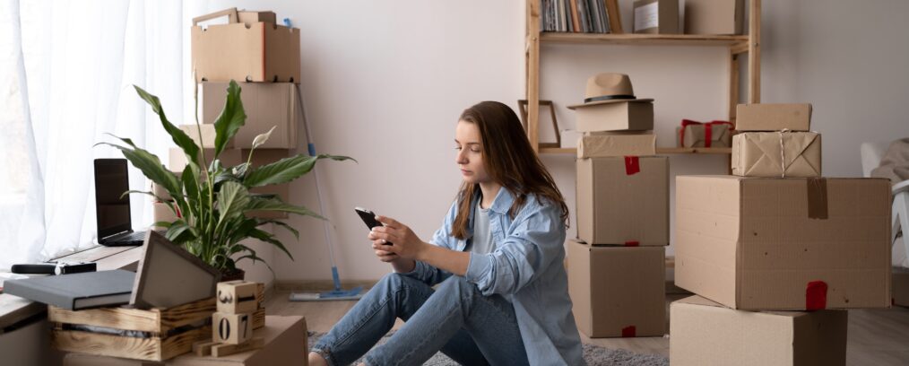 Young adult woman moving into her own apartment.