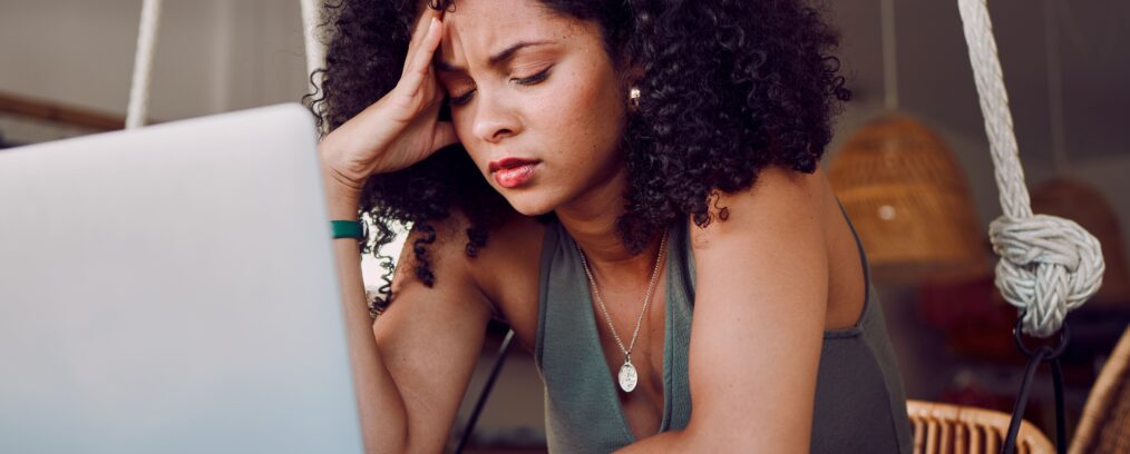 Woman struggling with anxiety at her desk.