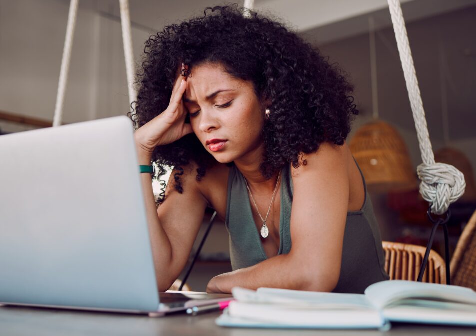 Woman struggling with anxiety at her desk.