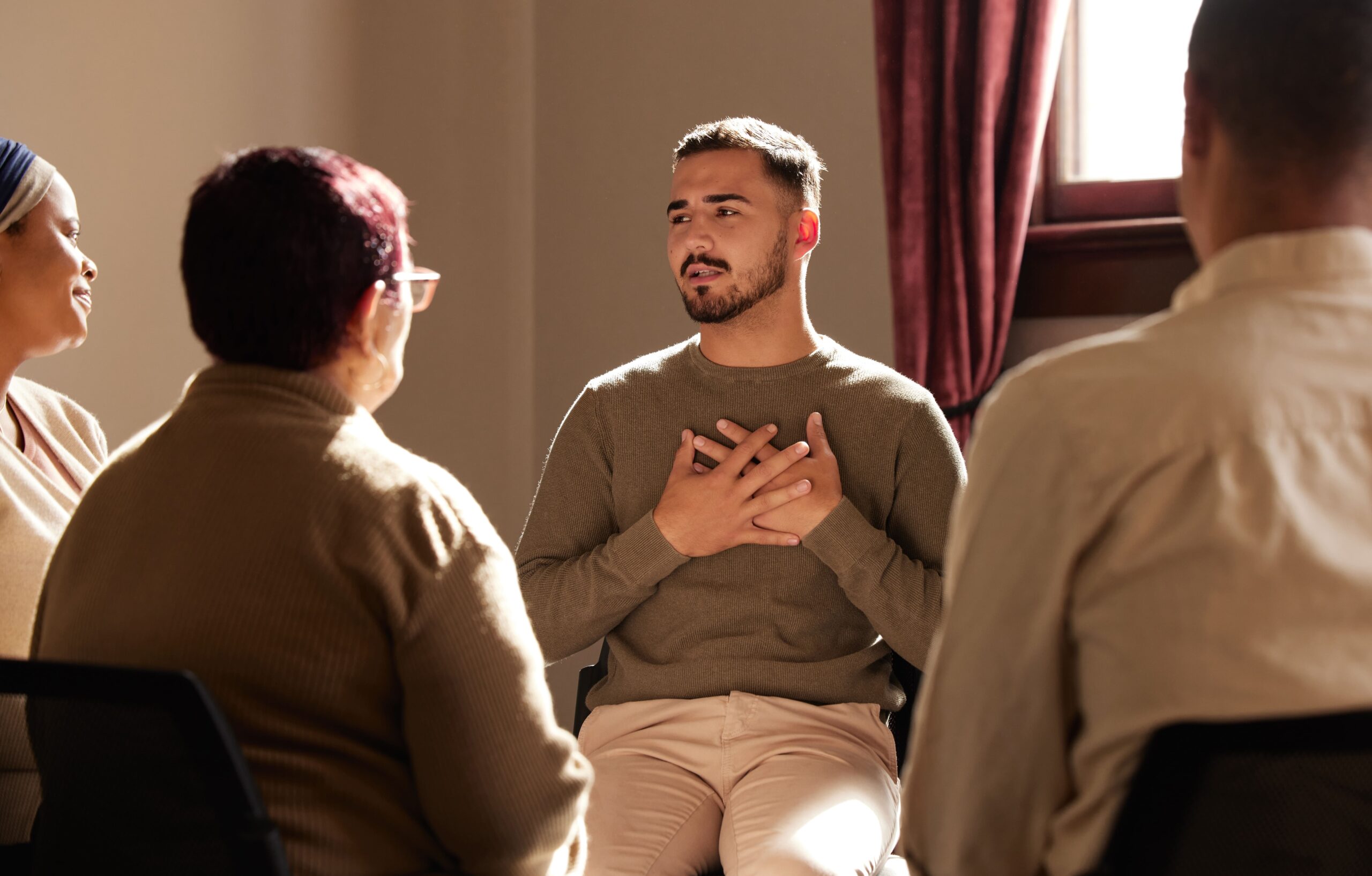 Young man participating in group therapy.