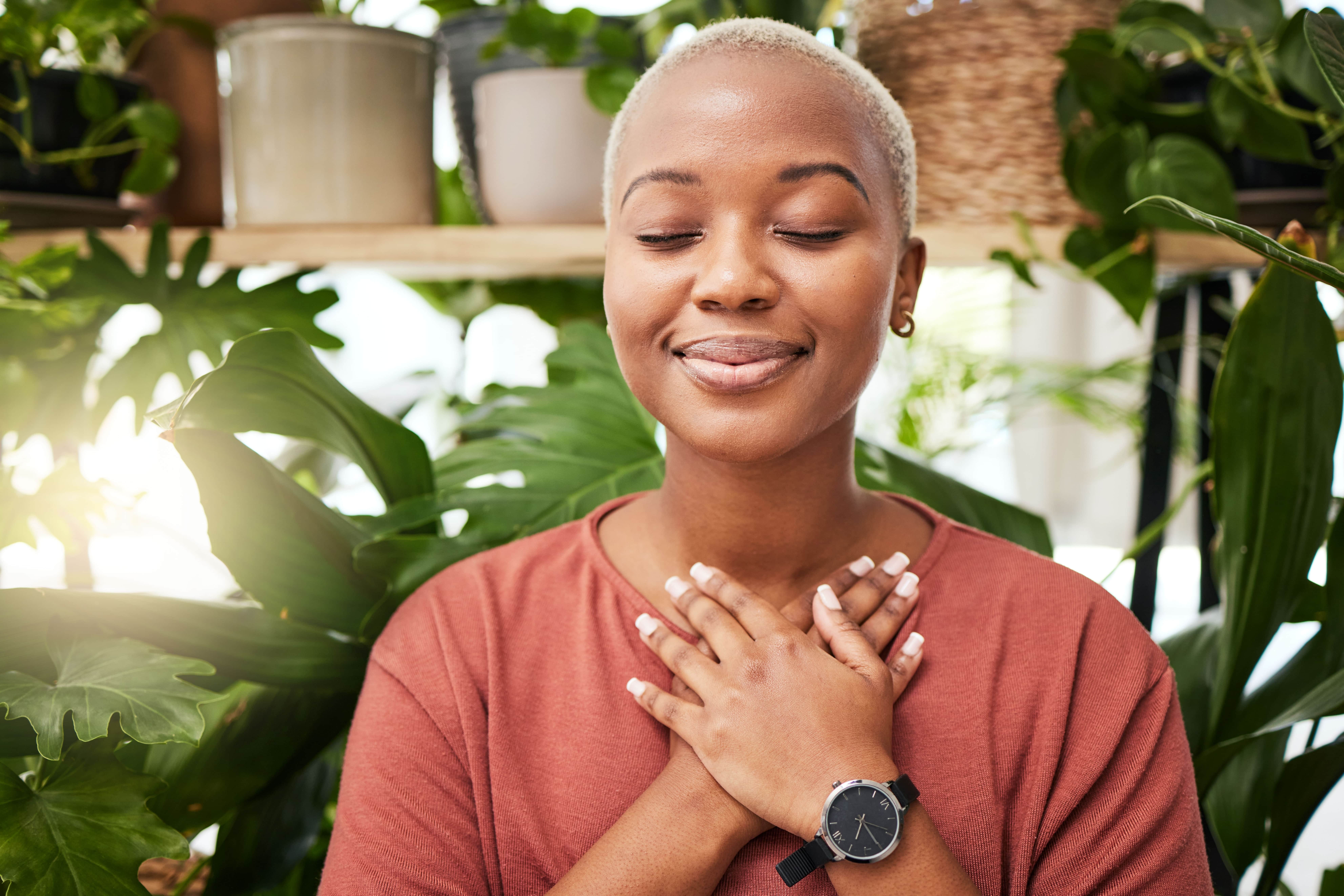 Young adult woman smiling and showing self love.