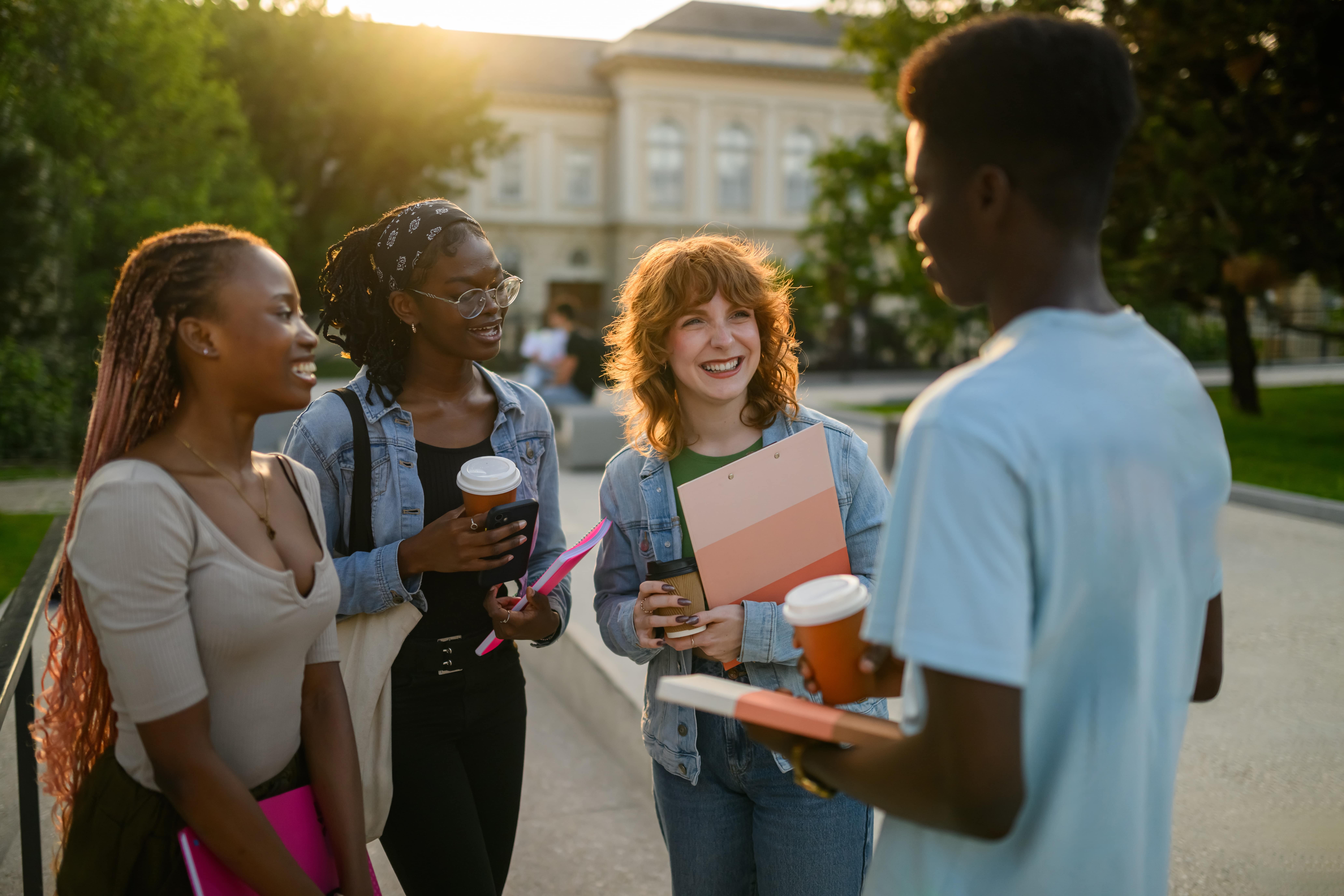 Group of young adults in college talking.