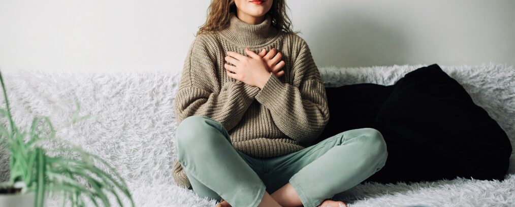 Woman meditating in her room.