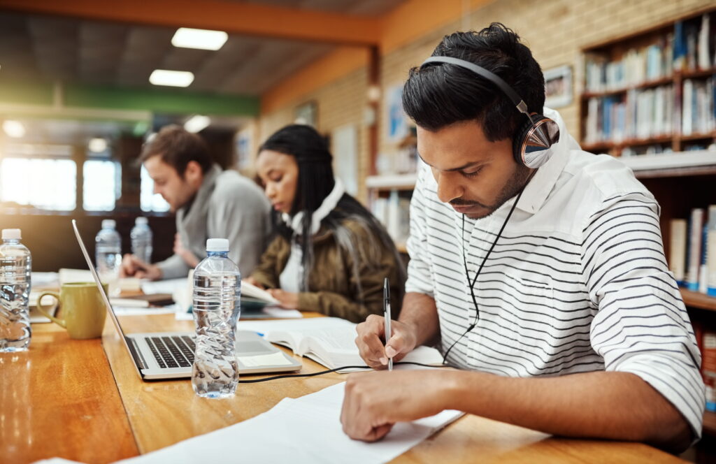 College students working individually at desks.