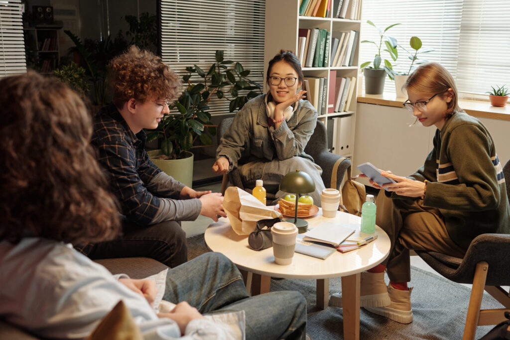 Young adults talking and sitting together. 