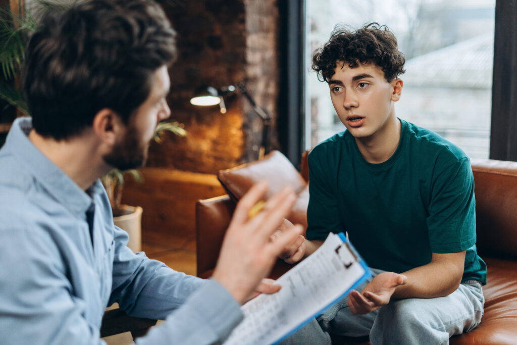 Young adult in a therapy session with a mental health professional.