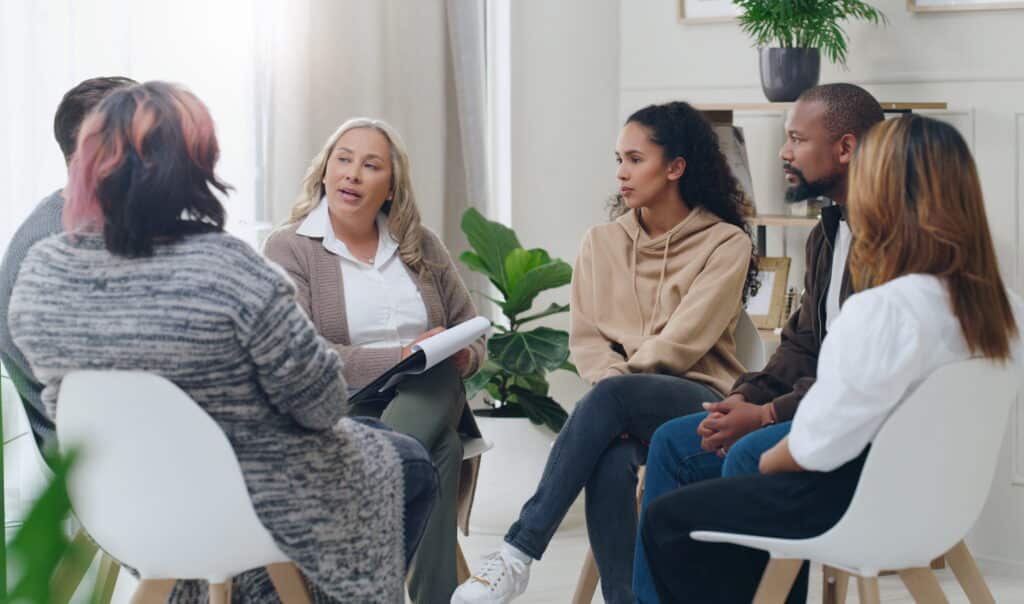 Group of adults participating in group mental health session.