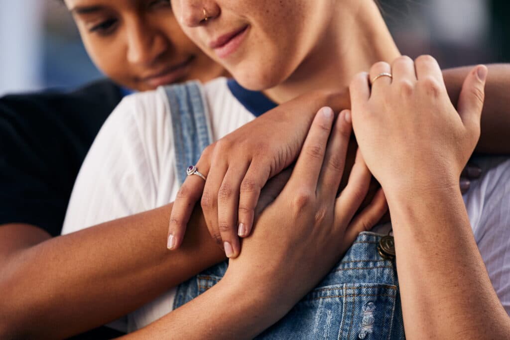 Two women comforting each other.