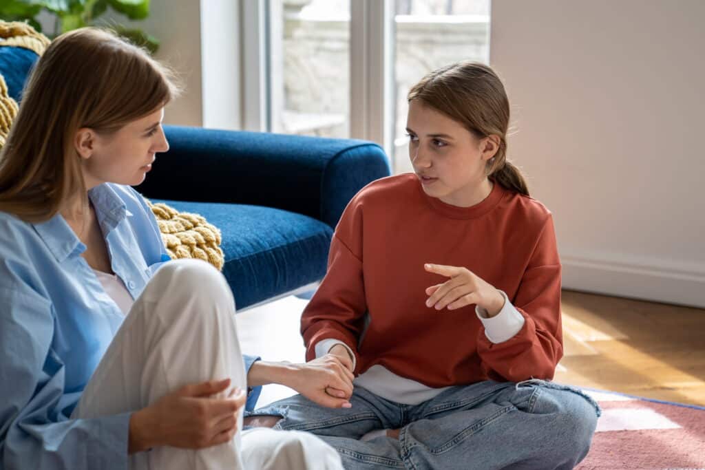 Teenage girl talking to her mother.