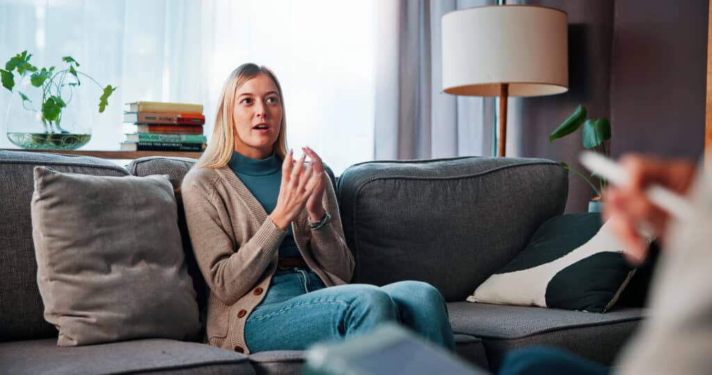 Young adult talking in a therapy session.