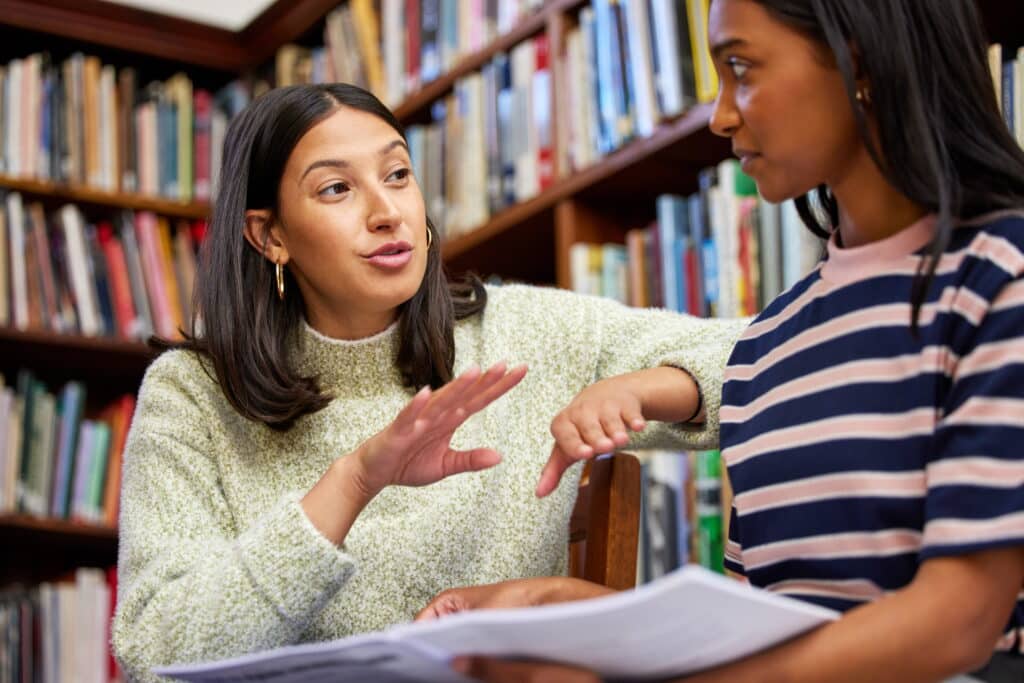 Young student talking to a teacher.